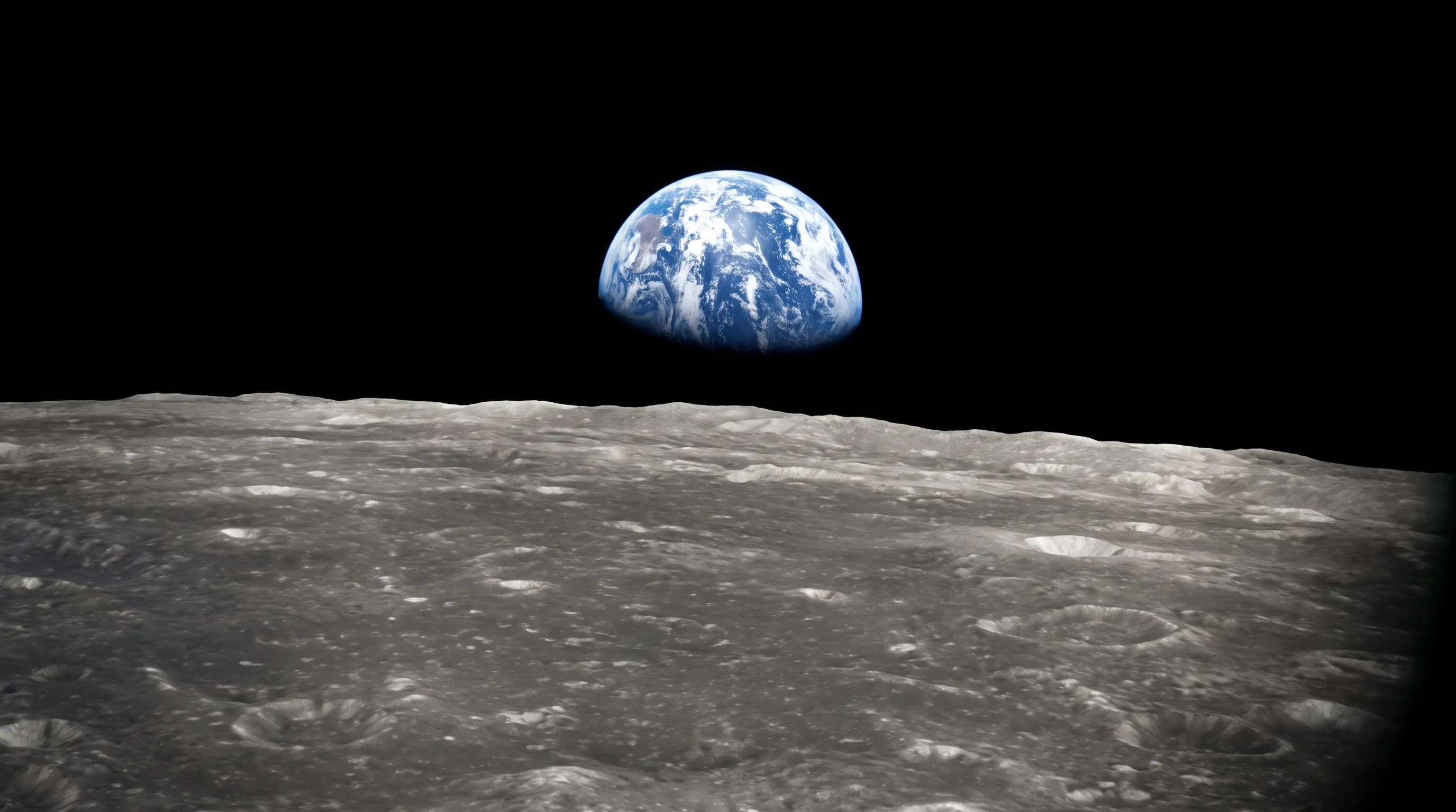 Artist’s concept of Earth rising above the sunlit lunar horizon, seen from the far side of the Moon.